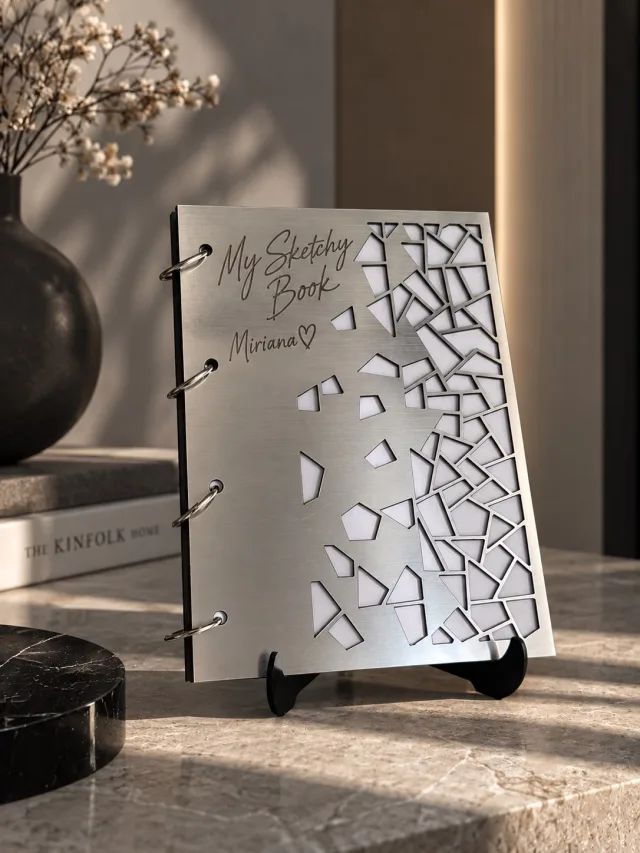 Metallic sketch book with elastic leather pen holder.